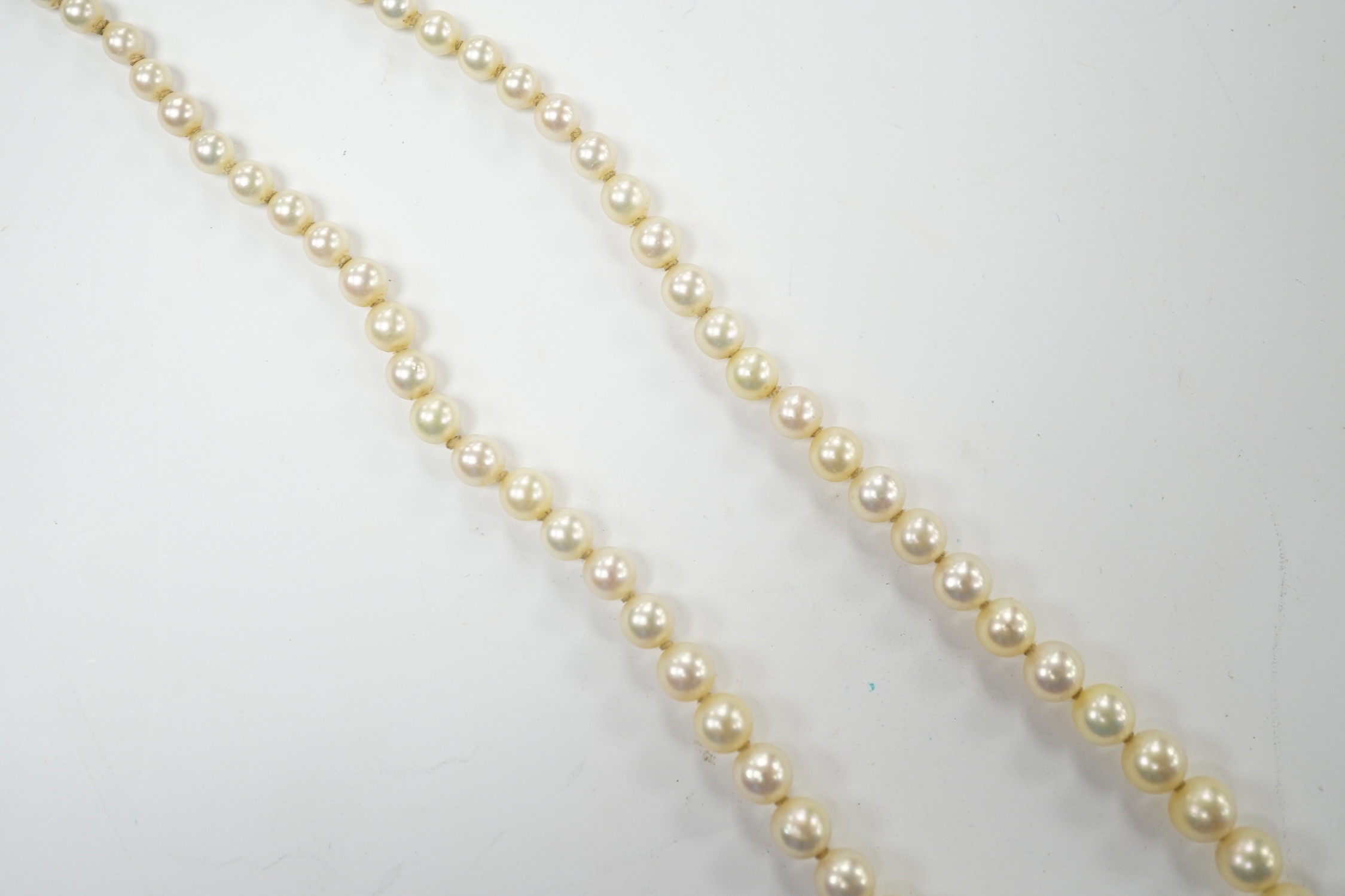 A single strand graduated culture pearl necklace, with cultured pearl set white metal clasp stamped 'silver', 38cm. Fair condition.